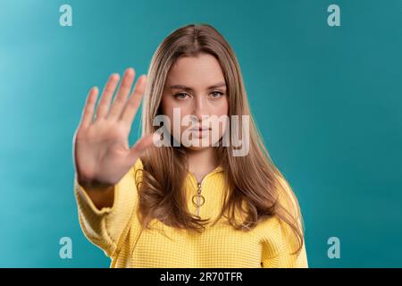 Uninterested woman disapproving with NO hand sign gesture. Denying, rejecting. Stock Photo