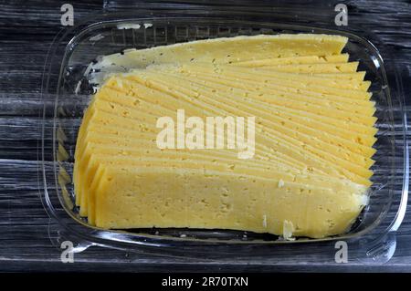 Slices of Egyptian Rumi cheese, also called gebna romiya or gebna turkiya, Roumi, Romi also Romy, middle Eastern parmesan hard cheese, has a pungent s Stock Photo