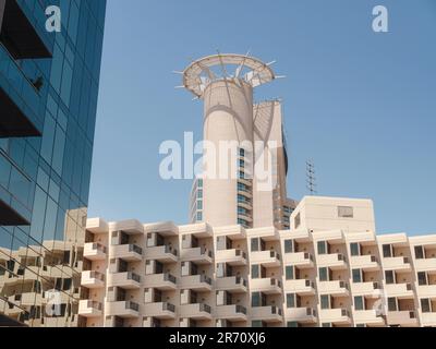 Abu Dhabi, UAE - March 19, 2023: Abu Dhabi Mall and Beach Rotana Hotel. View from the water, of the Beach Rotana Hotel and the Abu Dhabi Mall, with reflections. Stock Photo