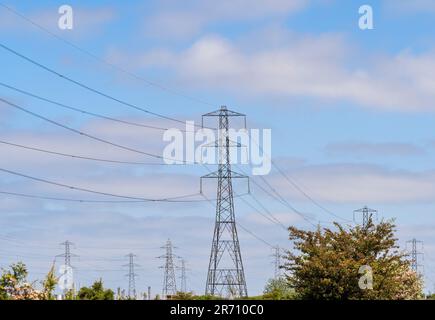 Electricity pylons and overhead power lines at the National Grid Salthome substation in Stockton-on-Tees, seen against a blue sky. UK. Stock Photo