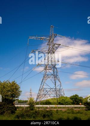 Electricity pylon and overhead power lines at the National Grid Salthome substation in Stockton-on-Tees, seen against a blue sky. UK. Stock Photo