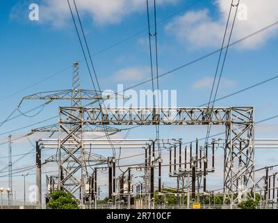 Overhead power cables seen against a blue sky at National Grid Salthome substation in Stockton-on-Tees. UK Stock Photo