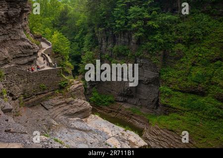Hikers explore the gorge at Lucifer Falls located at Robert H. Treman State Park in Ithaca in the Finger Lakes Region of New York State during the sum Stock Photo