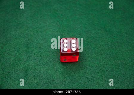 Red Dice on a green baize tabletop Stock Photo