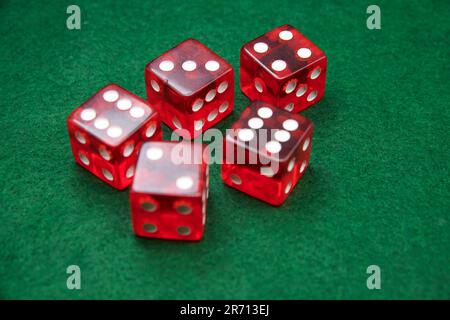 Red Dice on a green baize tabletop Stock Photo