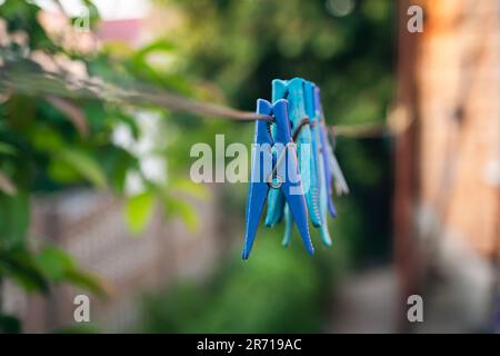 Multi-colored clothespins on a clothesline close up. Stock Photo
