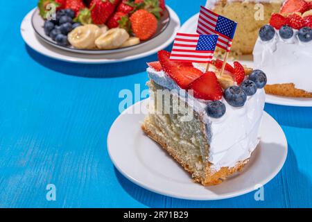 4th of July cake with flag and berries. Homemade Patriotic American flag striped vanilla cream sponge cake, Holiday Party summer dessert Stock Photo