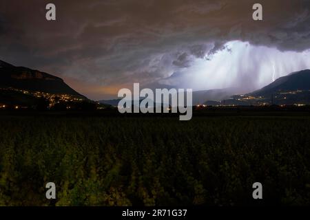 Lightning bolt over the Adige Valley during a thunderstorm, seen from Margreid, South Tyrol, Italy Stock Photo