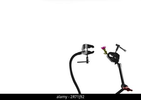 A robot arm appears to receive a romantic flower from another robot arm Stock Photo