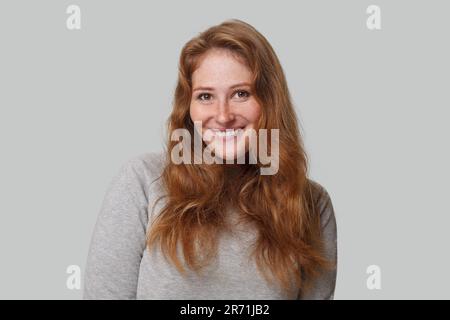 Cheerful redhead woman smiling on white background Stock Photo