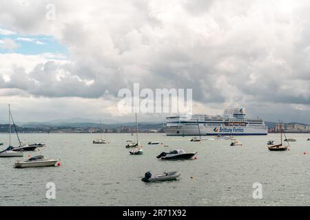 Beautiful Santander Bay in a cloudy day. Boats docked in the middle of the bay area. View of BRITTANY FERRIES ship docked in the Santander terminal Stock Photo