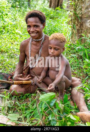 Woman of the Korovai tribe with a child. Tribe of Korowai (Kombai , Kolufo). June 10, 2016 in Onni Village, New Guinea, Indonesia Stock Photo