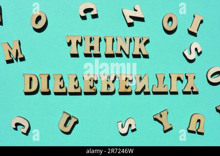 Think Differently, words in wooden alphabet letters isolated on background Stock Photo