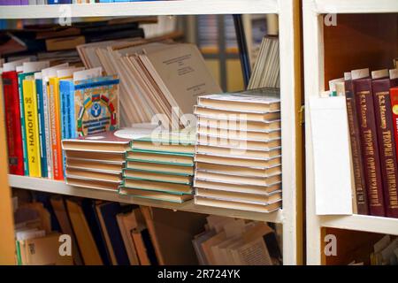 Chapaevsk, Samara region, Russia - December 24, 2020: Books on a shelf in the library. Selective focus Stock Photo