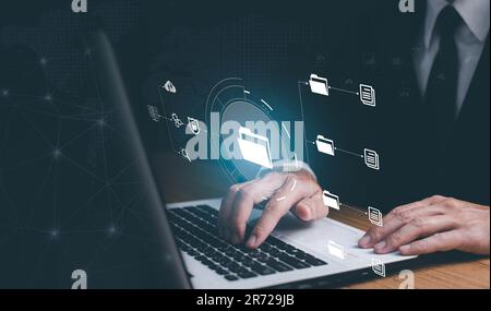 Online documentation database and document management system concept. Businessman working on laptop with virtual screen. Process automation to efficie Stock Photo