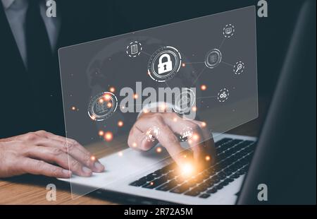 Businessman typing on keyboard laptop computer to input username and password for technology security system and prevent hacker concept. Stock Photo