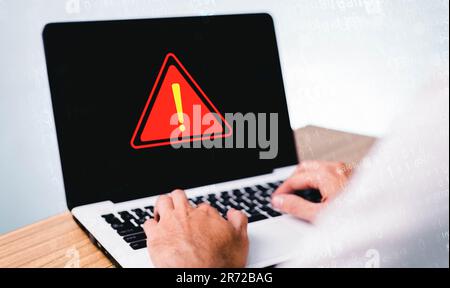 Businessman or it staff , programmer, developer using computer laptop with triangle caution warning sign for notification error and maintenance concep Stock Photo