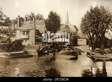 A 1933 view of Pull's Ferry, Norwich, UK. It is a former ferry house located on the River Wensum and once served as a watergate for the cathedral. It is named after John Pull, who ran the ferry from 1796 to 1841 and was previously Sandling's Ferry. The Ferry ceased operating in 1943 Stock Photo