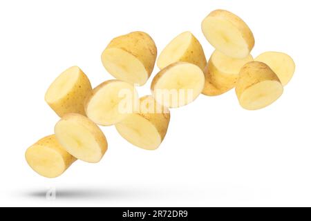 Flying vegetables. Flying potato halves and wedges isolated on white background. Isolate fresh potatoes cut into slices and large pieces. Stock Photo