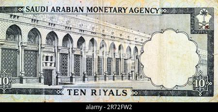 Large fragment of the reverse side of 10 SAR Saudi Arabia riyals cash money currency banknote features Al-Masa Wall with arch at Al-Masjid al-Haram (H Stock Photo