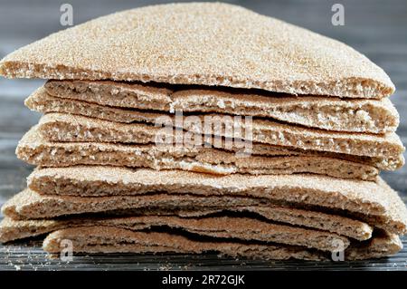 Brown baked pitta bread flatbread made mainly in bran, Bran breads used for sandwiches and beside meals, popular in Egypt, brown circular and round ba Stock Photo