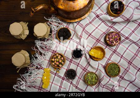 There are various tea additives on the checkered tablecloth. High quality photo Stock Photo