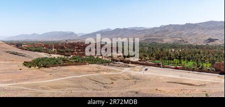 View of Tamenougalt village with its typical clay houses in the Draa valley, Morocco Stock Photo