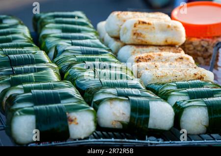 Vietnamese snack food sticky rice wrapped by green leaf from Vietnam local street market. Stock Photo