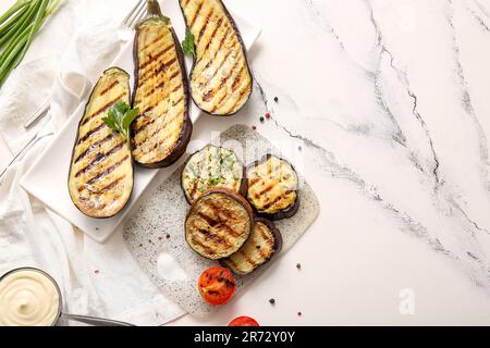 Composition with delicious grilled eggplants on light background Stock Photo