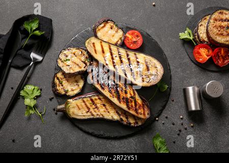Composition with delicious grilled eggplants on dark background Stock Photo