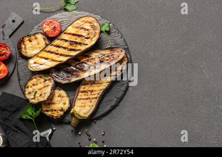 Composition with delicious grilled eggplants on dark background Stock Photo