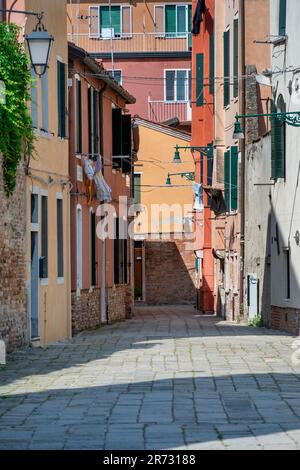 Scene with the narrow streets and the old medieval red brick buiuldings in Venice, Italy. Stock Photo