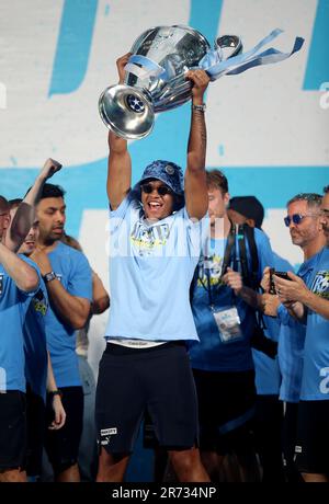 Manchester City's Manuel Akanji celebrates on stage with the Champions League trophy during the Treble Parade in Manchester. Manchester City completed the treble (Champions League, Premier League and FA Cup) after a 1-0 victory over Inter Milan in Istanbul secured them Champions League glory. Picture date: Monday June 12, 2023. Stock Photo