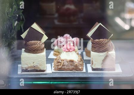 A tempting selection of beautifully decorated cakes and pastries displayed in a bakery shop window frequented by locals and tourists, La Coruna, Spain. Stock Photo