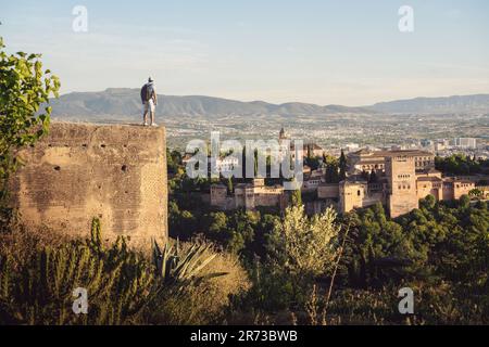 Tourist looking at Alhambra view from San Miguel Alto Viewpoint - Granada, Andalusia, Spain Stock Photo