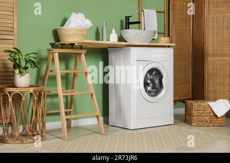 Stylish laundry room with functional washing machine. Interior design ...