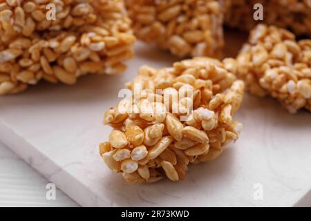Puffed rice bars (kozinaki) on white table, closeup Stock Photo