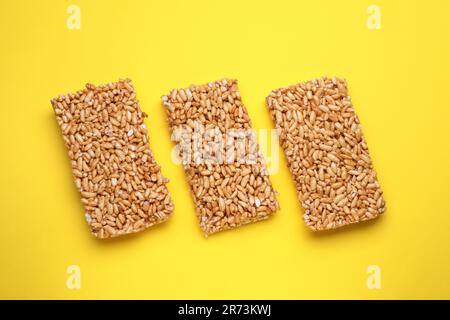 Puffed rice bars (kozinaki) on yellow background, flat lay Stock Photo