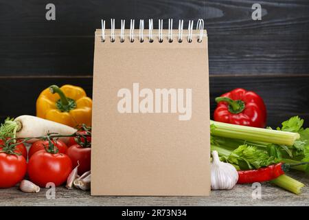 Blank recipe book and different ingredients on wooden table. Space for text Stock Photo