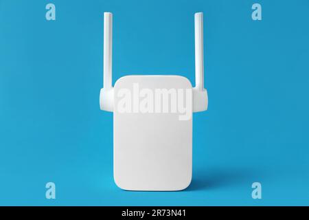 New modern Wi-Fi repeater on blue background Stock Photo