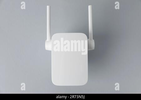 New modern Wi-Fi repeater on light gray background Stock Photo