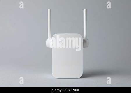 New modern Wi-Fi repeater on light gray background Stock Photo