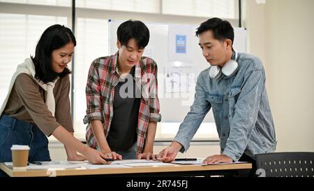 A group of professional Asian UI, UX graphic designers, or developers is in the meeting, brainstorming and planning a new project together. Stock Photo