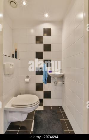 Interior design of contemporary toilet room with round mirror lamp small  black sink white walls with beige small square tiles Stock Photo - Alamy