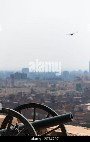 Old cannon with Cairo city in the background seen from Muhammad Ali mosque Stock Photo