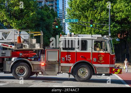 City of Atlanta Fire Department ladder truck crossing Peachtree Street en route to an emergency situation in Midtown Atlanta, Georgia. (USA) Stock Photo