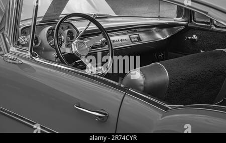 Old vintage car with steering wheel and cockpit. Retro styled image of an old car inerior with radio inside, classic car Chevrolet-April 30, 2023-Vanc Stock Photo