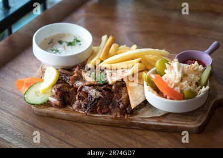 Shawarma lamb with coleslaw and chips. Middle eastern food. Stock Photo