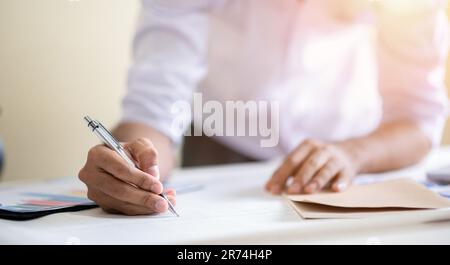 Business man working with laptop and documents on his desk.analyzing data in office Stock Photo