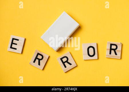 A word made of letters - error and eraser on a yellow background. Stock Photo